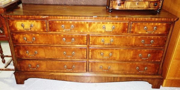 A 20th century mahogany sideboard with an arrangement of nine drawers.
