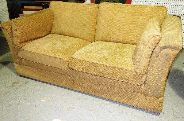 A cream upholstered two seat sofa.