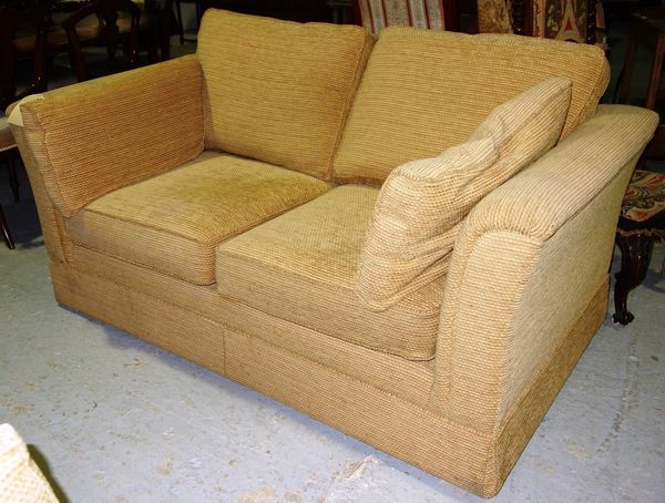 A cream upholstered two seat sofa.