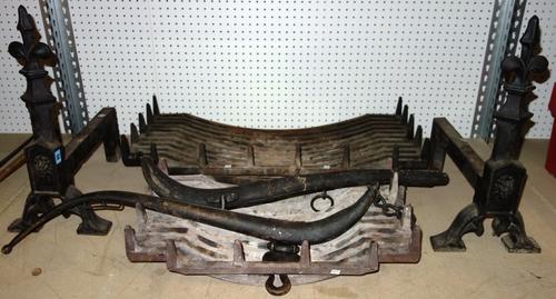 A pair of cast iron fire dogs, and two cast iron baskets. (3)