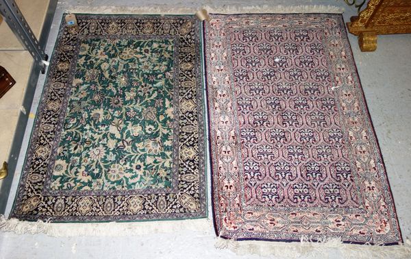 A silk Indian rug, the sage field with all over floral sprays, a black palmette border, 115cm x 77cm, and an Indian silk rug, the indigo field with a