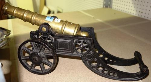 A 19th century brass and cast iron model of a cannon.