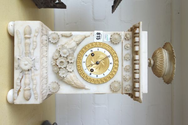 An alabaster and parcel gilt mantel clock, late 19th century, with all over foliate carved embellishments and an urn finial, (a.f), 43cm high.