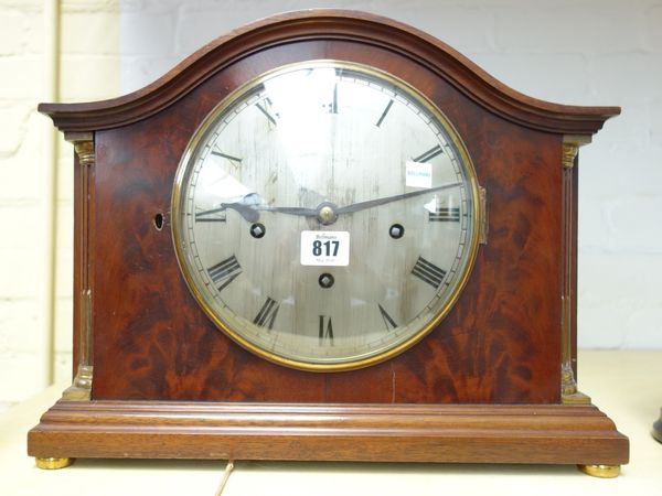A mahogany cased mantel clock, circa 1900, the domed top over a silvered 7.5 inch dial detailed 'Mappin and Webb', flanked by brass inlaid pillars, on