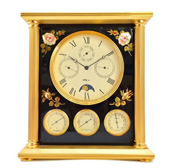 A Swiss Imhof clock/weather station, multi dial, with pillar supports and lacquered sides, 23cm high.  Illustrated