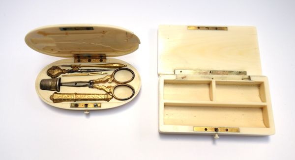 An ivory cased etui, 19th century, oval, monogrammed lid enclosing a gilt metal sewing set (11.5cm wide) and an early 20th century rectangular ivory b