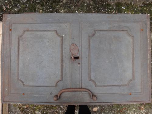 A cast iron strong box, 19th century, with side carrying handles. 100cm wide across the handles.