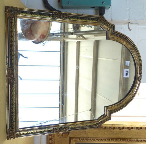 A tortoiseshell and brass Boulle work strut back mirror, early 19th century, the domed rectangular frame with gilt foliate embellishments and ornate B