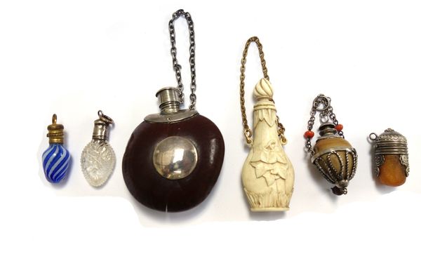 A novelty scent bottle made from a conker or similar nut, with white metal mounts, 5cm, together with a late 19th century foliate carved ivory scent b
