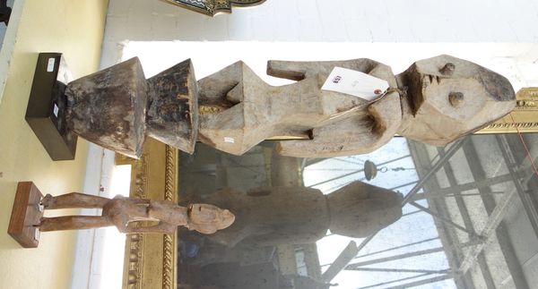 A West African large female totem or ancestor figure carved in softwood and a small carved female figure, 93 x 32cm high, (2).