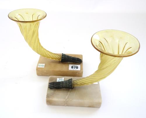 A pair of cornucopia shaped yellow glass vases, with bronze glove finials on alabaster plinths, 12.5cm high, and a pair of patinated spelter two handl