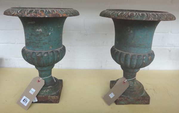 A pair of polychrome painted cast iron urns, early 20th century, of small proportions, each on a square foot, 33cm high. (2)