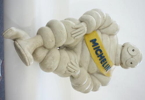 A Michelin 'Bibendum' man with metal mount to rear (57cm) and a Mercedes Benz vintage enamel circular sign, (40cm diam), (2).