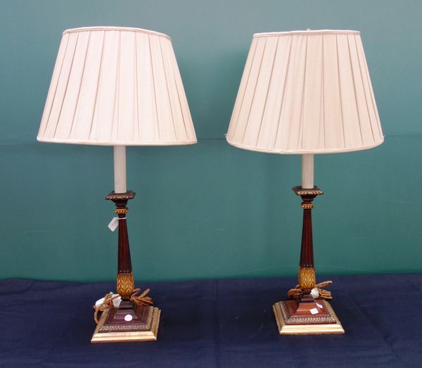 A pair of Georgian style mahogany table lamps, with fluted and gilt fluted columns on square bases, fitted for electricity (2).