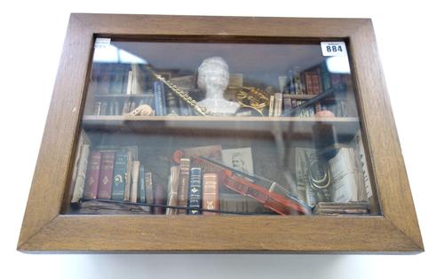 Ettore Sobrero glazed cased diorama, containing an interior scene comprising books and musical instruments, 39cm wide.