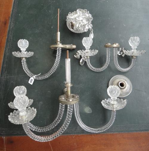 A pair of five branch wall lights with baguette and pear shaped drops and prism finials, 70cm high.