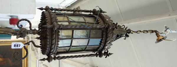 A bronze and patinated metal lantern, late 19th century, of Gothic form, the pierced and shaped conical top over a circular green glazed body, surroun