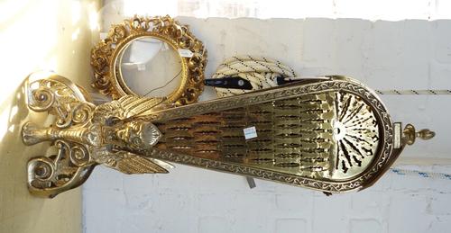 A brass folding fire screen, 62cm high, together with a pair of Italian Florentine giltwood carved circular picture frames and five motoring grill bad