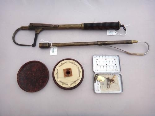 A Hardy Bros Bakelite fishing line box of circular form, detailed with lines, flys and hooks, 10cm diameter, together with a small slim alloy fly tin,