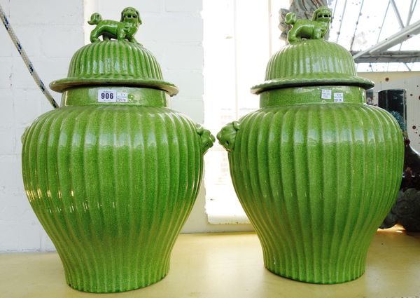 A pair of modern Chinese style pottery vases and covers, with green fluted ground and dog of Fo finials, 53cm high, and a Chinese style black ground p