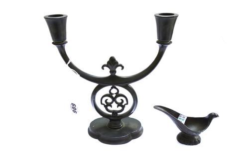A Just Anderson bronze twin branch candelabra with shaped base, 21cm diameter and a Danish novelty bronze pipe holder cast as a bird, 7cm high (2).
