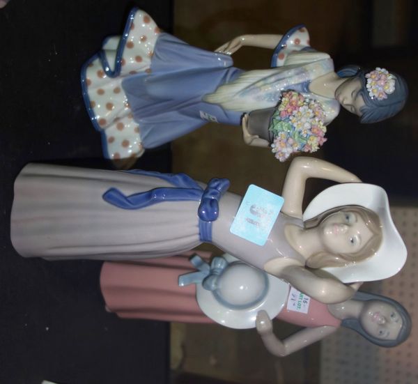 A group of three Iladro figures; 'Girl with bonnet', 'Oriental girl with flowers' and 'Girl in pink holding hat'. (3) Unboxed.