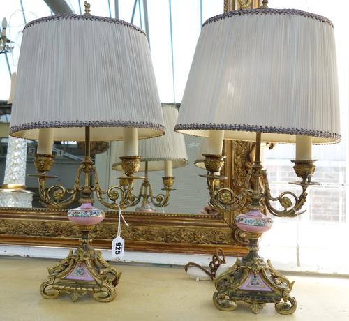 A pair of Louis Philippe Sevres style porcelain and ormolu two light candelabra, the stem with rose pompadour over a triform base and scroll feet, wit