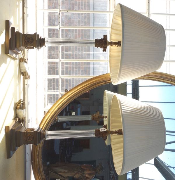 A pair of brass and glass mounted table lamps, 20th century, each of corinthian column form, with pleated shades, 52cm high excluding fitments. (2)