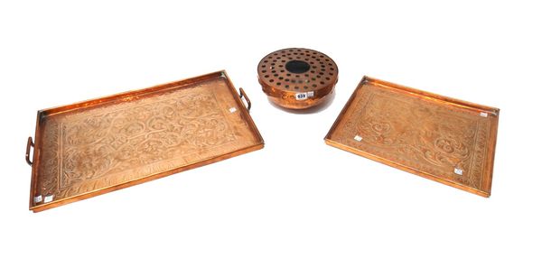 Two Keswick Arts and Crafts copper trays, early 20th century, of rectangular form, one embossed in relief with birds amongst foliage, 42cm long, the o