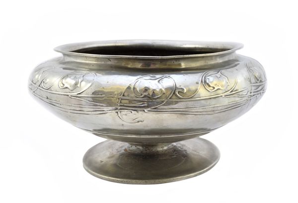 Archibald Knox for Liberty & Co, a large pewter footed bowl centrepiece, circa 1900, of squat form, raised on a circular disc foot, with embossed styl