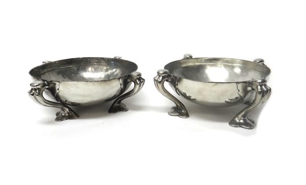 Attributed to Liberty & Co, two pewter centrepiece bowls, early 20th century, of round shape, raised on scroll legs terminating in trifid feet, 26.5cm