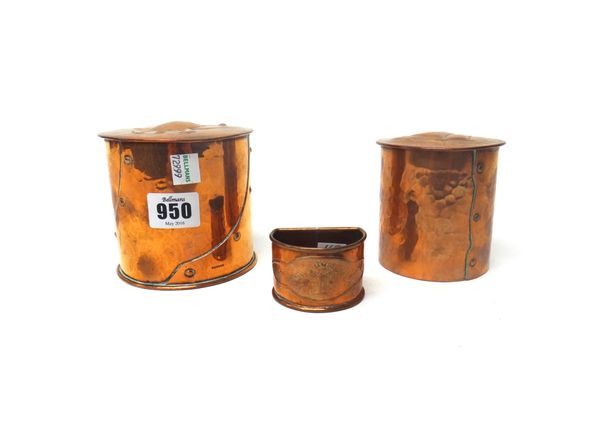 Two copper boxes and a Keswick copper napkin ring, early 20th century, each box of cylindrical form, one by Newlyn, 10cm high. (3)