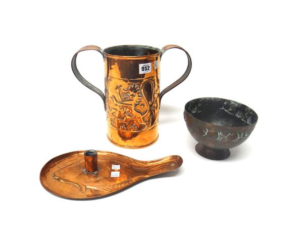 Three copper pieces, early 20th century, comprising; a twin-handled vessel by Keswick, with embossed lion and thistle design, 23.8cm high, a candlesti