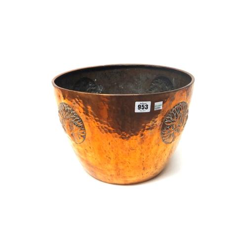 A WMF copper jardiniere, early 20th century, decorated in relief with four stylised trees on a planished surface, with stamped factory mark, 35cm diam