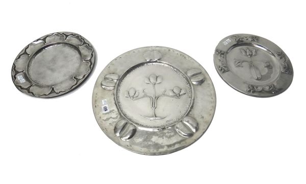 A large Liberty's polished pewter charger, embossed with an Art Nouveau three branch foliate design, numbered 0208, 46cm diameter, another Liberty & C