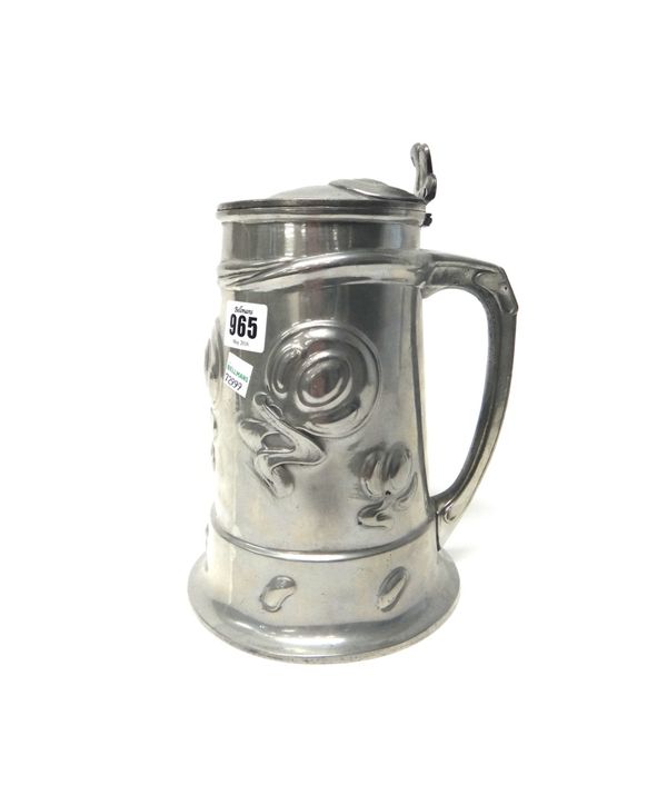A Liberty & Co large pewter tankard, the design attributed to Oliver Baker, relief cast with an Art Nouveau foliate band, numbered 054, 24.5cm high.