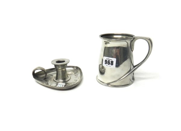 A Tudric pewter mug of Art Nouveau style, the design attributed to Oliver Baker, numbered 066, 11cm high, together with a Tudric pewter taperstick wit