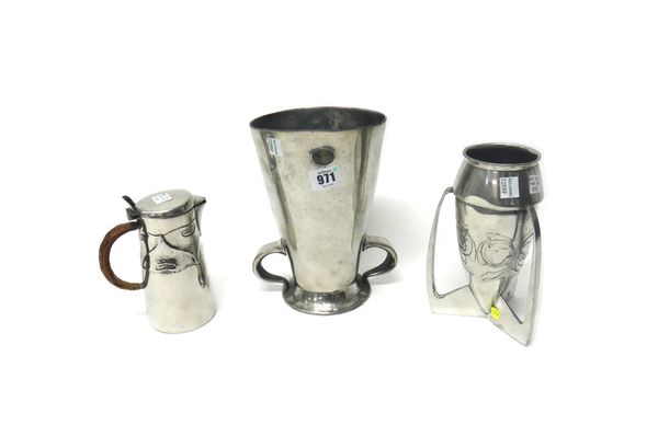 Liberty & Co; an English pewter jug with a basket weave handle, 15cm high, a Tudric tapering cylindrical vase with green hardstone inset mounts, and a