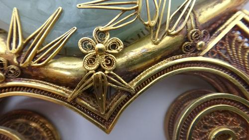 A pair of Tudric pewter vases, of swept naturalistic curving form, each with single side handle and foliate cast shaped base, numbered 0213, 34cm high