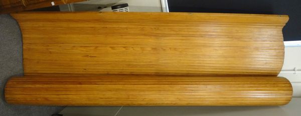A pine tambour screen/room divider, with maker's plaque 'S.N.S.A.', with three shaped tops, 200cm wide x 200cm high.