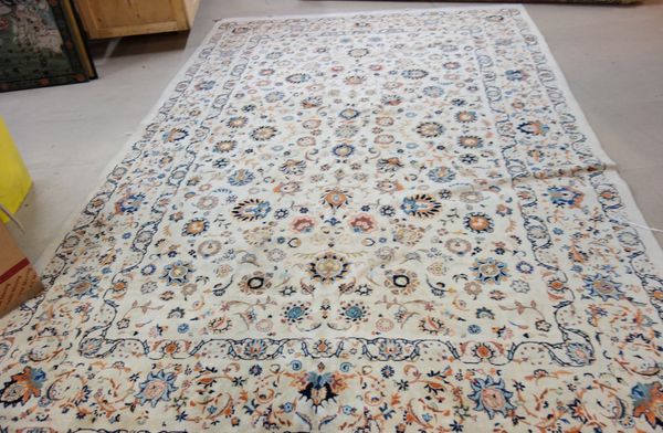 A Kashan carpet, Persian, the cream field with an allover floral design, a complementary border, 396cm x 262cm.