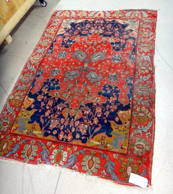 An unusual Indian rug, the small dark blue main field with central large spreading orange/red medallion centred with four botehs, golden yellow spandr