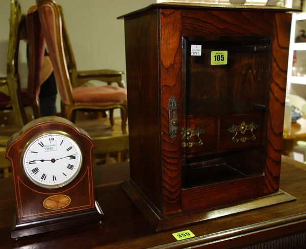 An early 20th century oak smoker's cabinet and a mantel clock. D6