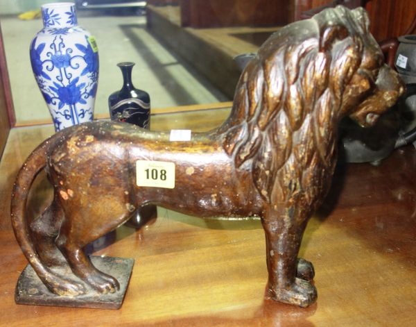 A Victorian cast iron figure of a lion, 32cm long.  CAB
