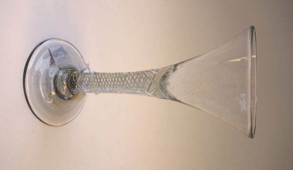 A mid 18th century wine glass, with drawn trumpet bowl and multi series airtwist stem, 16.5cm high.Property from the estates of the late Adrian Stanfo