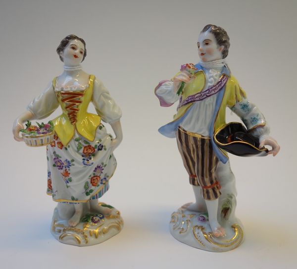 A pair of 20th century Meissen porcelain figures modelled as a gallant and companion, on gilt C scroll bases, with blue crossed swords and incised mar