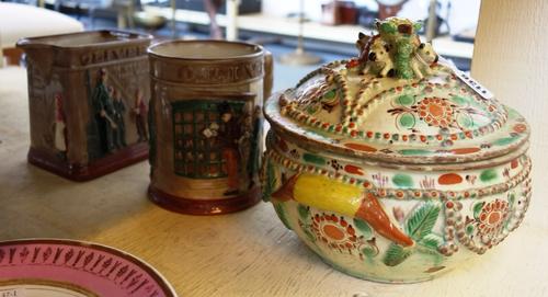 A Swiss or South German pottery bowl and cover, 19th century, (a.f.), 21cm diameter and two Royal Doulton 'Oliver' Dickens ware jugs.