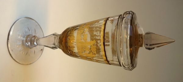A Bohemian Zwischengold cut glass goblet and cover, circa 1740, the bowl engraved in gold foil with a continuous hunting scene above a scroll band, ab