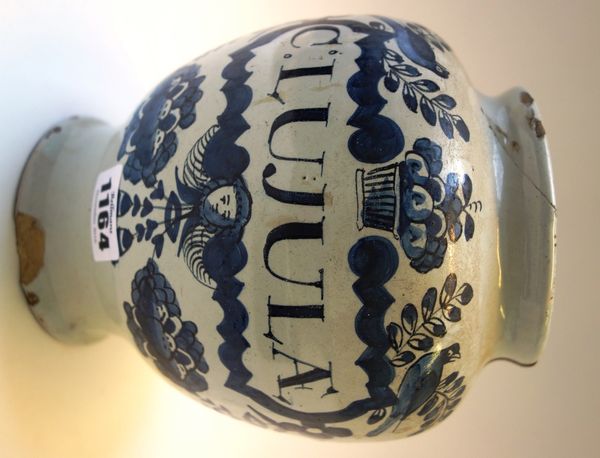 An English delftware dry drug jar, 18th century, detailed C: LUJULAE in blue against an off white ground (a.f.) 17cm high.