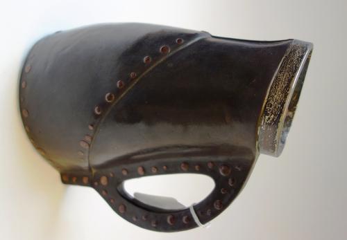 A Doulton Lambeth stoneware jug, simulating a leather black jack, late 19th century, with applied silver mount to rim, 22.5cm high.